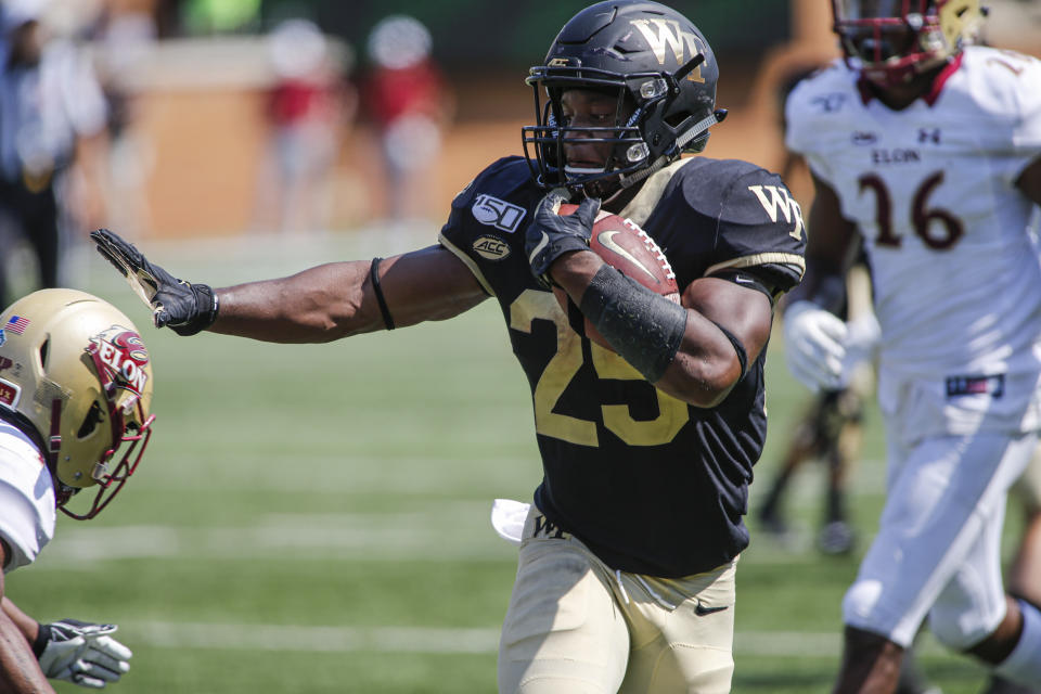 Wake Forest running back Kenneth Walker stiff arms an Elon defender on his way to scoring a touchdown in the second half of an NCAA college football game in Winston-Salem, N.C., Saturday, Sept. 21, 2019. Wake Forest won 49-7. (AP Photo/Nell Redmond)