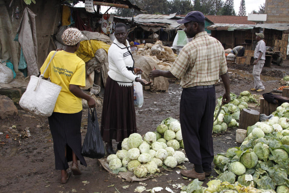 A woman buys cabbages in a vegetable market, Tuesday, May 15, 2012 in the Kibera slum in Nairobi, Kenya. According to a U.N. African Development Report, nearly 218 million people on the African continent are undernourished and 55 million children are malnourished, a figure that is projected to rise. The report says food security can be achieved by several means, including boosting agricultural productivity and creating resilience against natural disasters. Tegegnework Gettu, an assistant secretary-general and regional director for the UNDP bureau in Africa, said chronic food security in sub-Saharan Africa stems from decades of poor governance. (AP Photo/Khalil Senosi)