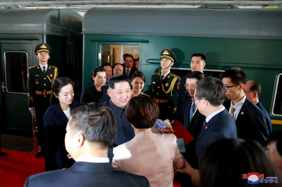 Kim Jong un greets well wishers as he departs (AFP)