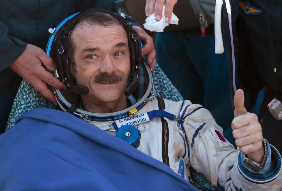 Canadian astronaut Chris Hadfield gestures with a thumbs up after the Russian Soyuz space capsule landed some 150 km (90 miles) southeast of the town of Zhezkazgan, in central Kazakhstan May 14, 2013. The first Canadian astronaut to command the International Space Station (ISS) landed safely in Kazakhstan with two crewmates on Tuesday, wrapping up a five-month mission aboard the ISS.