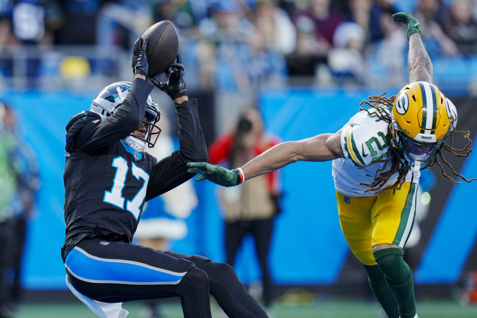 Carolina Panthers wide receiver DJ Chark Jr. catches a touchdown pass ahead of Green Bay Packers cornerback Eric Stokes during the second half of an NFL football game Sunday, Dec. 24, 2023, in Charlotte, N.C. (AP Photo/Rusty Jones)