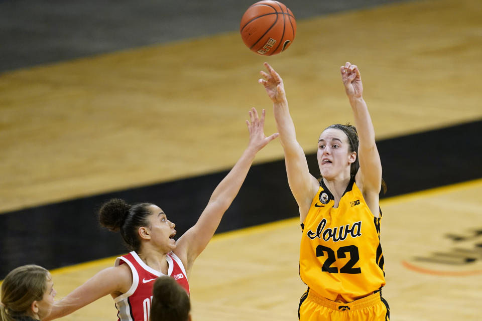 Iowa guard Caitlin Clark (22) shoots over Ohio State guard Madison Greene during overtime in an NCAA college basketball game Wednesday, Jan. 13, 2021, in Iowa City, Iowa. Clark, one of the top scorers in the nation, has been named the Big Ten's player of the week three times this season and has won the conference's freshman of the week honor six times. (AP Photo/Charlie Neibergall)