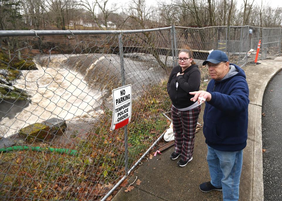 Mike Goor and his niece Holly Ackerman, both of Norwich, and many others, came to see the Yantic Falls raging after heavy flooding of the Yantic River in Norwich Wednesday.