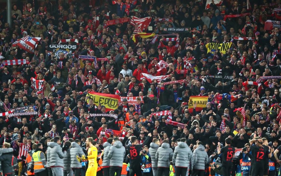Supporters of Atletico Madrid celebrate after the UEFA Champions League round of 16 second leg match between Liverpool FC and Atletico Madrid at Anfield on March 11, 2020 in Liverpool, United Kingdom - Alex Livesey - Danehouse