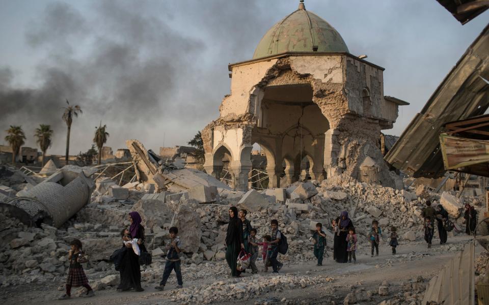 Civilians fleeing destroyed neighbourhood of Mosul's Old City - Credit: AFP