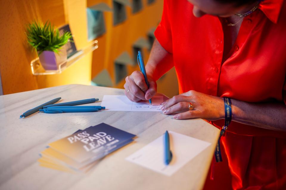 Sarah Hardy, cofounder of formula-maker Bobbie, writes a letter to her representative at the evening celebration at Union Market, hosted by Paid Leave for All and Glamour.