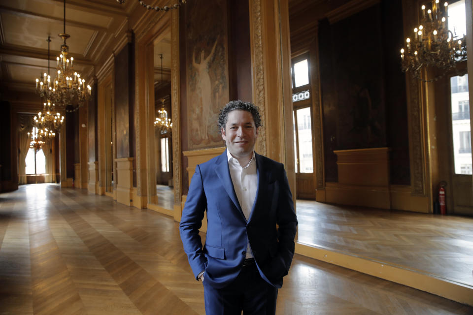 Venezuelan conductor Gustavo Dudamel poses after a press conference at the Palais Garnier opera house, in Paris Friday, April 16, 2021. The Paris Opera announced the arrival of Gustavo Dudamel as music director for six seasons. (AP Photo/Christophe Ena)