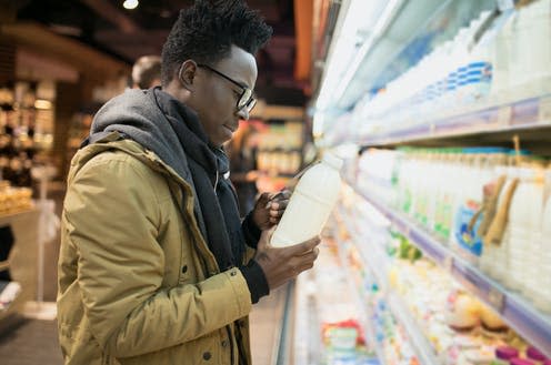 <span class="caption">Can food labelling really help us make 'better' choices?</span> <span class="attribution"><a class="link " href="https://www.shutterstock.com/image-photo/african-man-holding-choice-milk-yogurt-768413047" rel="nofollow noopener" target="_blank" data-ylk="slk:AntGor/Shutterstock;elm:context_link;itc:0;sec:content-canvas">AntGor/Shutterstock</a></span>