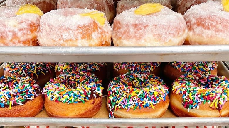 Frosted donuts on metal trays