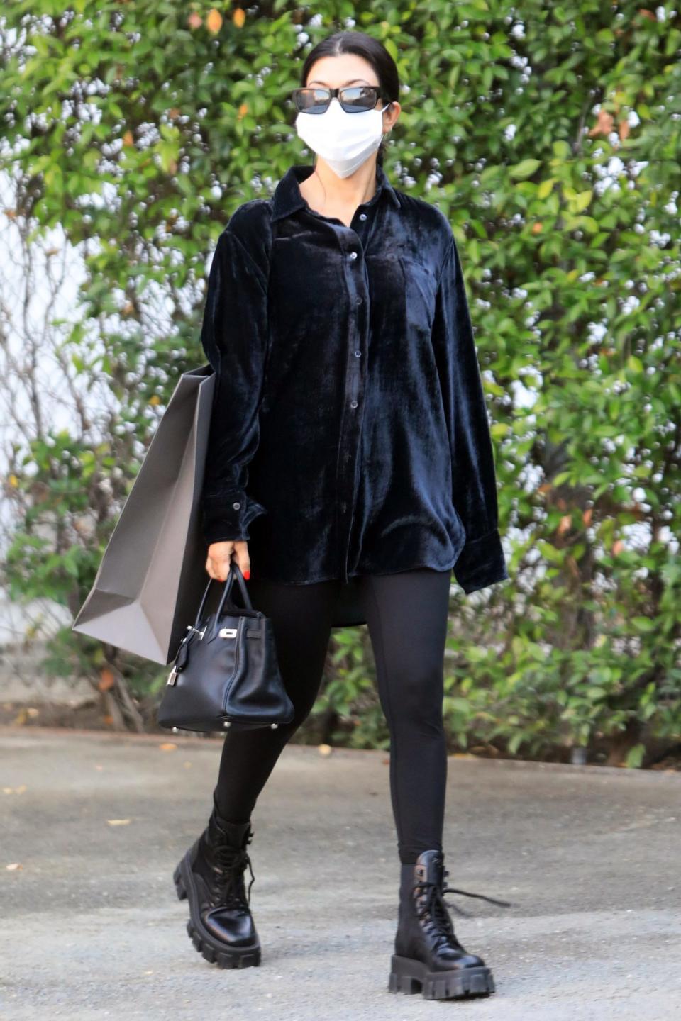 <p>Kourtney Kardashian goes shopping in L.A. on Thursday, wearing all black. </p>