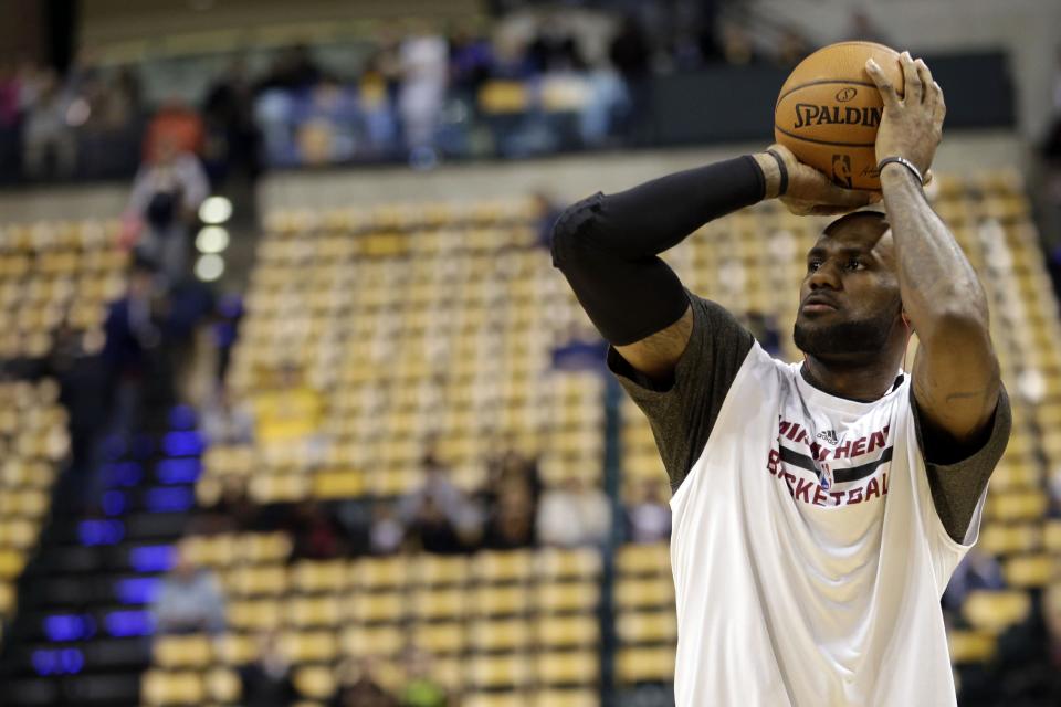 Miami Heat forward LeBron James warms up before the start of an NBA basketball game against the Indiana Pacers in Indianapolis, Wednesday, March 26, 2014. (AP Photo/AJ Mast)