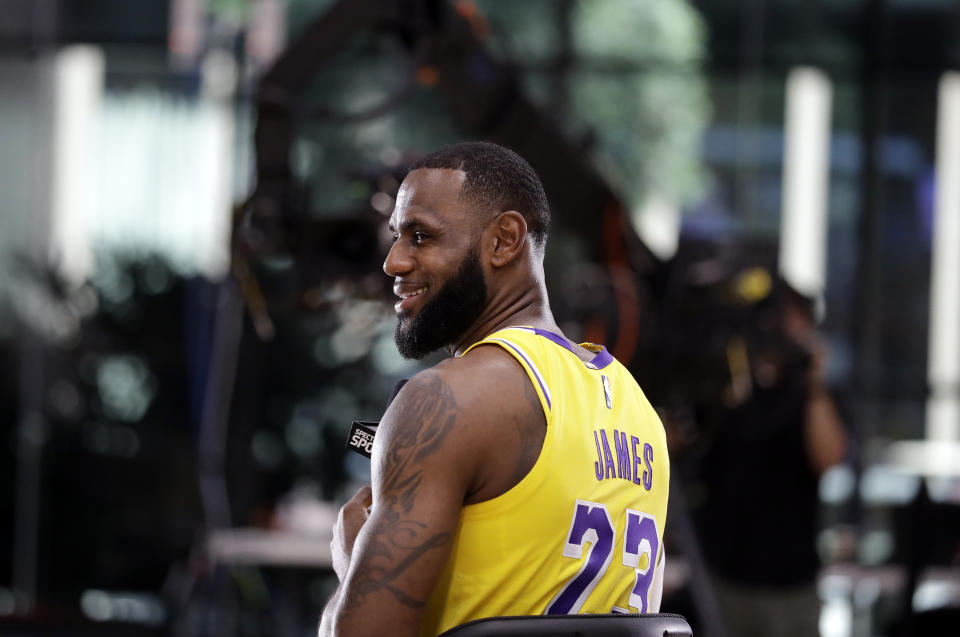 Los Angeles Lakers' LeBron James smiles as he answers questions during media day at the NBA basketball team's practice facility Monday, Sept. 24, 2018, in El Segundo, Calif. (AP Photo/Marcio Jose Sanchez)
