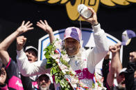 Helio Castroneves of Brazil celebrates after winning the Indianapolis 500 auto race at Indianapolis Motor Speedway in Indianapolis, Sunday, May 30, 2021. (AP Photo/Michael Conroy)