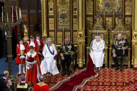 Britain's Queen Elizabeth II sits beside her husband Prince Philip, as she delivers delivers the Queen's Speech alongside Prince Charles, and Camilla, Duchess of Cornwall, during the State Opening of Parliament in central London, on May 18, 2016. REUTERS/Justin Tallis/Pool