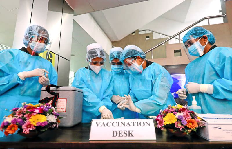 FILE PHOTO: Health officials prepare the AstraZeneca's COVID-19 vaccines manufactured by the Serum Institute of India, at army Hospital in Colombo