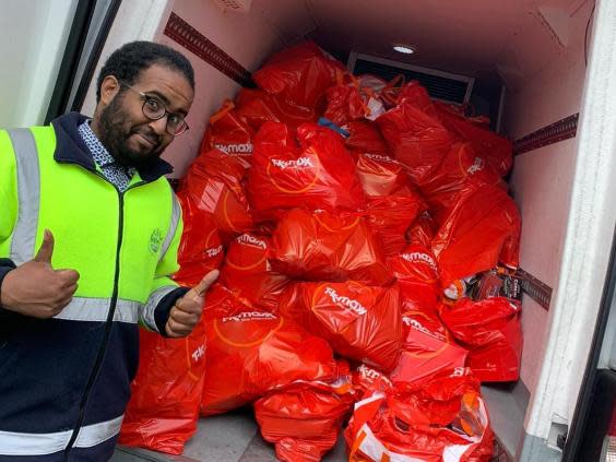 City Harvest volunteer Mohamed Elmi picking up surplus biscuits from TK Maxx (City Harvest)