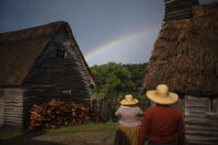 Museum educators playing the role of Pilgrims look at a rainbow over Plimoth Plantation, a living history museum village, Wednesday, Aug. 12, 2020, in Plymouth, Mass. The year 2020 was supposed to be a big one for Pilgrims. Dozens of events, from art exhibits and festivals to lectures and a maritime regatta featuring the Mayflower II, a full-scale replica, were planned to mark the 400th anniversary of the religious separatists' arrival at what we now know as Plymouth, Mass. (AP Photo/David Goldman)