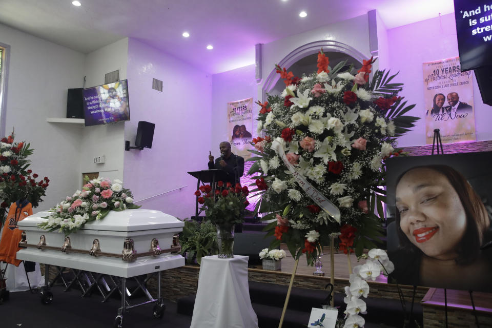 Pastor Elton Johnson, top center, conducts a funeral service in memory of Lydia Nunez, who died from COVID-19, at the Metropolitan Baptist Church Tuesday, July 21, 2020, in Los Angeles. (AP Photo/Marcio Jose Sanchez)