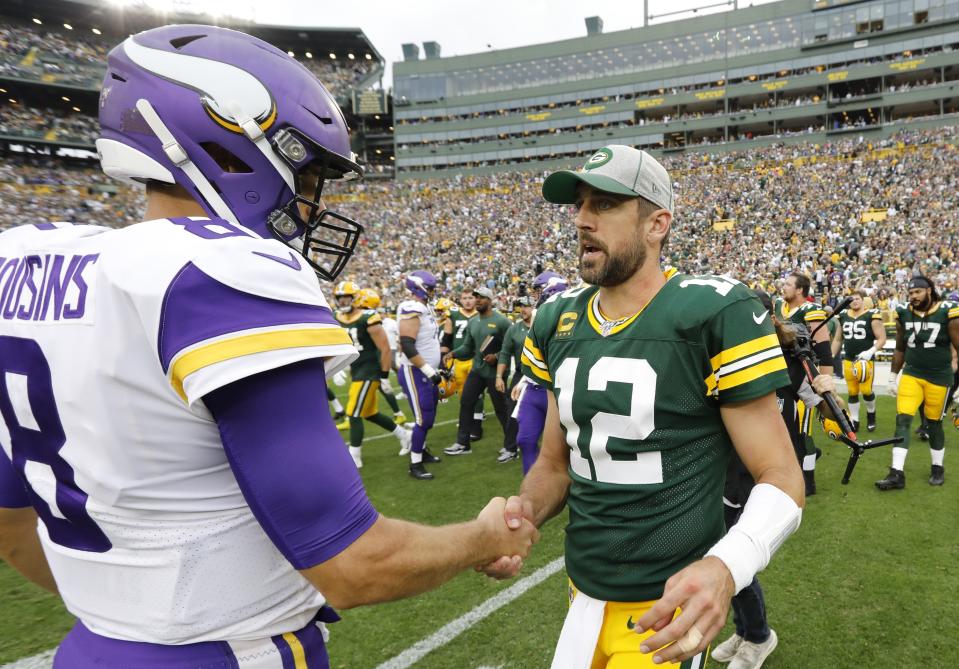 Green Bay Packers' Aaron Rodgers talks to Minnesota Vikings' Kirk Cousins after a game earlier this season. (AP Photo/Mike Roemer)