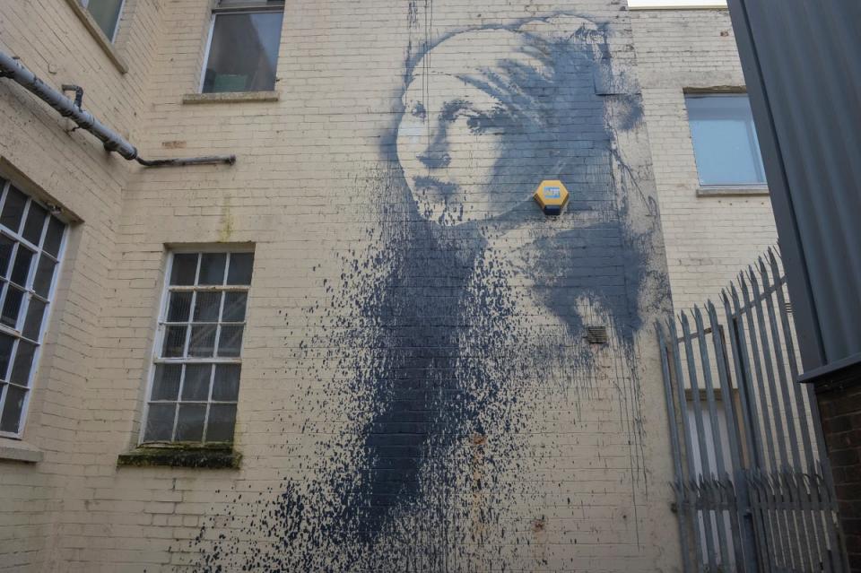 An outdoor security alarm replaces Vermeer’s pearl earring (PA)