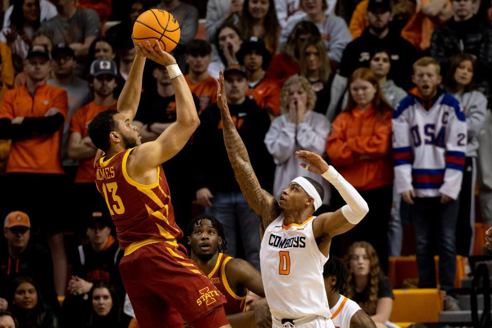 Iowa State's Jaren Holmes, left, shoots over Oklahoma State's Avery Anderson III in the first half of Saturday's game in Stillwater.