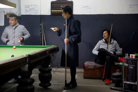 Men play snooker and gamble in a snooker hall in the capital city of Thimphu, Bhutan, December 12, 2017. REUTERS/Cathal McNaughton