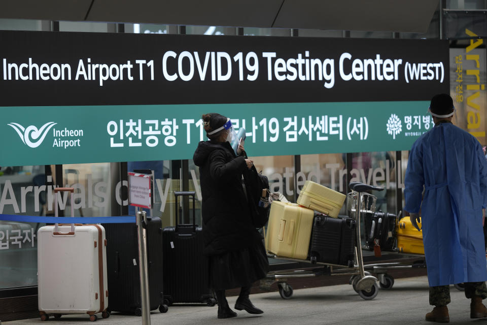 FILE - A woman arriving from China enters a COVID-19 testing center at the Incheon International Airport In Incheon, South Korea, Thursday, Jan. 5, 2023. China suspended visas Tuesday for South Koreans to come to the country for tourism or business in apparent retaliation for COVID-19 testing requirements on Chinese travelers. (AP Photo/Lee Jin-man, File)
