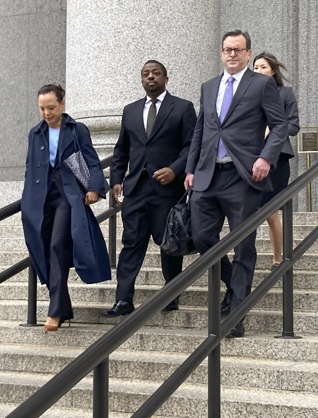 Former New York Lt. Gov. Brian Benjamin, center, leaves federal court, Thursday, May 12, 2022, in New York. A January trial date has been set for former New York Lt. Gov. Brian Benjamin to face charges that he traded his clout as a state senator for campaign contributions. (AP Photo/Larry Neumeister)