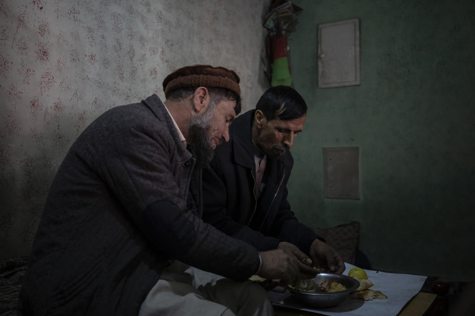 Staff members share a meal together in the Ariana Cinema in Kabul Afghanistan on Saturday, Nov. 6, 2021. After seizing power three months ago, the Taliban ordered cinemas to stop operating. (AP Photo/Bram Janssen)