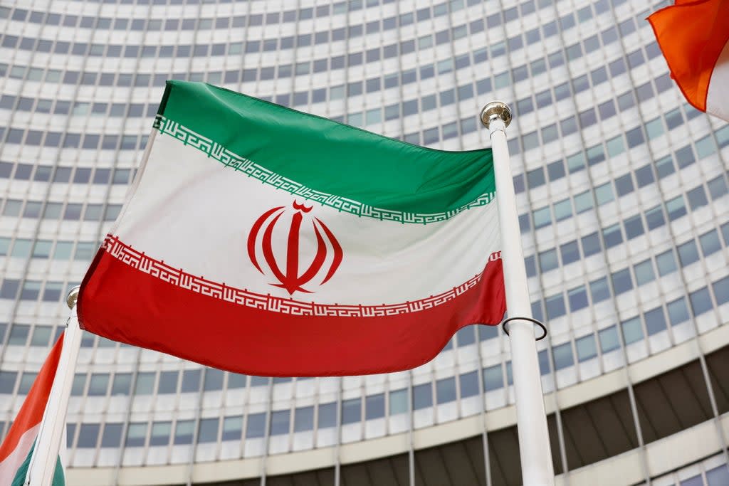 The Iranian flag waves in front of the International Atomic Energy Agency headquarters (REUTERS)