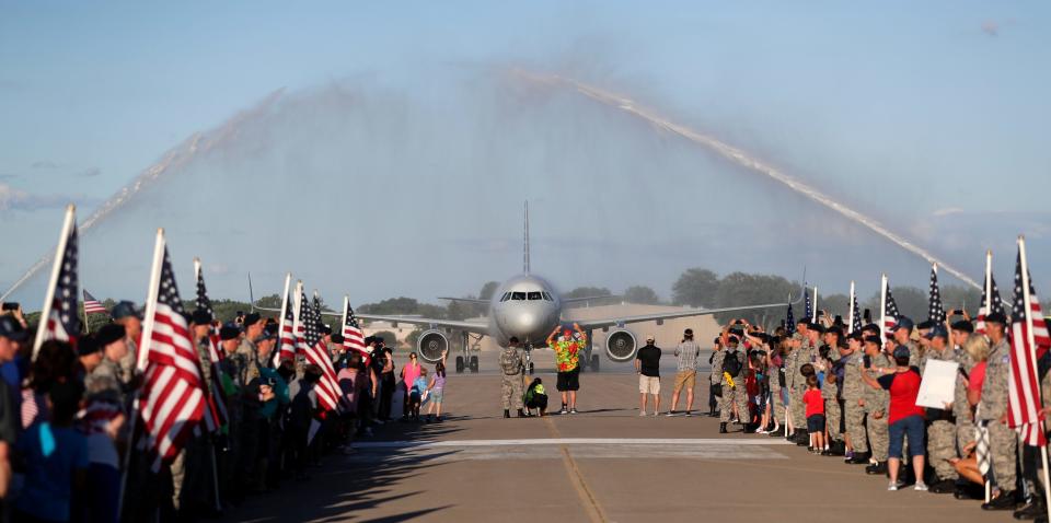 Veterans are welcomed back from a Yellow Ribbon Honor Flight with a water cannon salute on July 29, 2022, at EAA AirVenture Oshkosh 2022, in Oshkosh, Wis.
