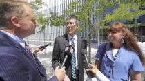 Mike and Becky Shamo, the parents of Aaron Shamo, speak with reporters at the federal courthouse Monday, Aug. 12, 2019, in Salt Lake City. Former Eagle Scout Aaron Shamo, 29, will stand trial on allegations that he and a small group of fellow millennials ran a multimillion-dollar empire from the basement of his suburban Salt Lake City home by trafficking hundreds of thousands of pills containing fentanyl, the potent synthetic opioid that has exacerbated the country's overdose epidemic in recent years. (AP Photo/Rick Bowmer)