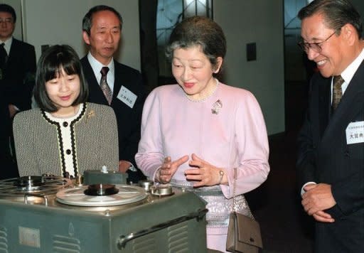 Japanese Empress Michiko (C) and her daughter Princess Nori look on a Sony's old type tape recorder as they visit the Sony Media World in Tokyo, in 1998, accompanied by then Sony Corp. Chairman Norio Ohga (R). Ohga, who helped transform the music industry with the development of the compact disc format, has died at the age of 81, the company said