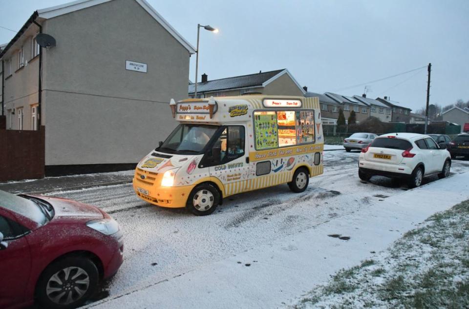 The snow must go on: An ice cream seller in Merthyr Tydfil didn’t let the weather stop him (PA)