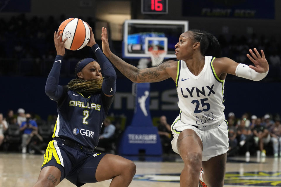 Dallas Wings' Odyssey Sims (2) works against Minnesota Lynx guard Tiffany Mitchell (25) in the first half of a WNBA basketball game, Thursday, Aug. 24, 2023, in Arlington, Texas. (AP Photo/Tony Gutierrez)