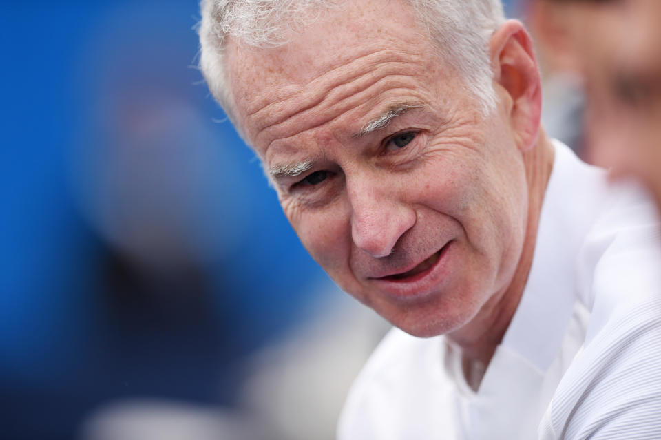 That's about as big as John McEnroe can smile, and he's clearly pleased at what he's seen from Milos Raonic this week.(Reuters / Tony O'Brien Livepic)