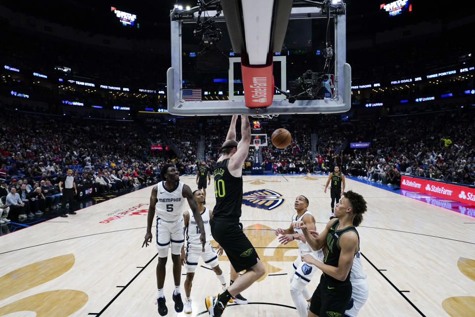 New Orleans Pelicans center Cody Zeller (40) slam dunks in the first half of an NBA basketball game against the Memphis Grizzlies in New Orleans, Tuesday, Dec. 19, 2023. (AP Photo/Gerald Herbert)