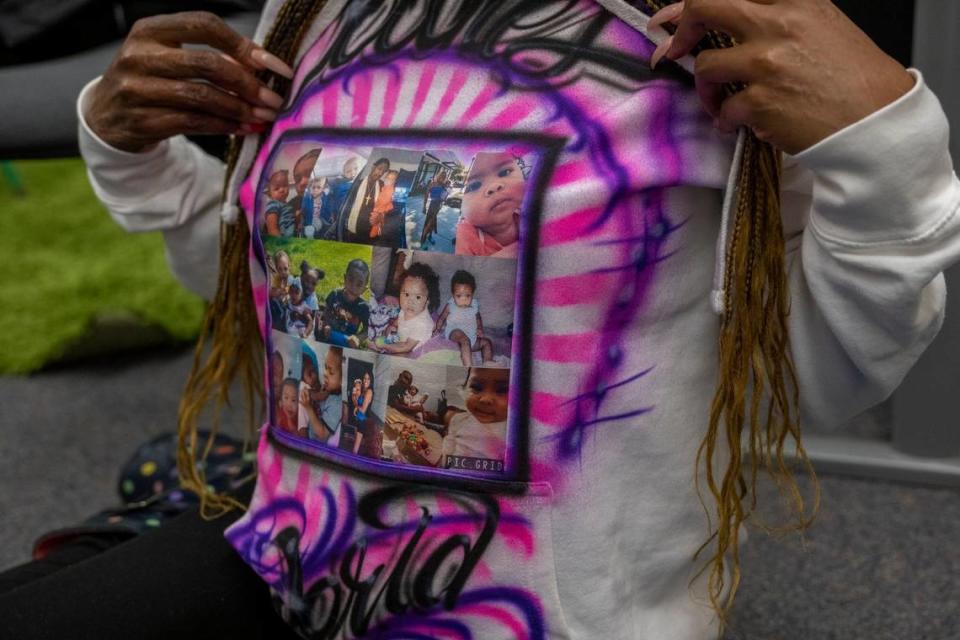 Marquisha Brown wears a sweatshirt on March 28, 2023, covered with pictures of her daughter Amanda, who was 16 months old when she was killed in 2021, and her son Elijah Washington, 6, who was beaten during the same domestic violence incident.