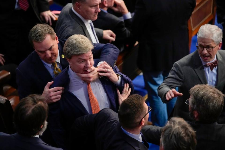 Richard Hudson, left, pulls Rep Mike Rogers back as he lunges at Matt Gaetz during the 14th round of voting for Speaker (Associated Press)