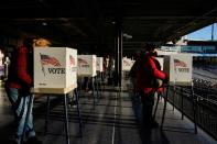 Voters fill out their ballots during early voting at ONEOK Field in Tulsa