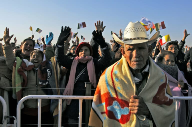 Catholic faithful wait for the arrival of Pope Francis in Ecatepec on February 14, 2016