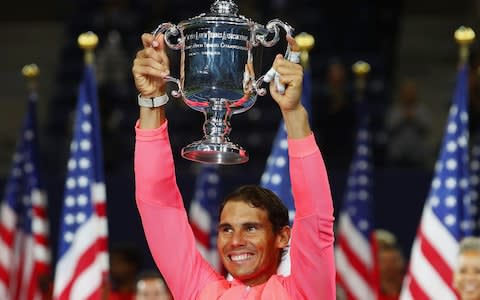 Rafael Nadal poses with the championship trophy - Credit: Getty