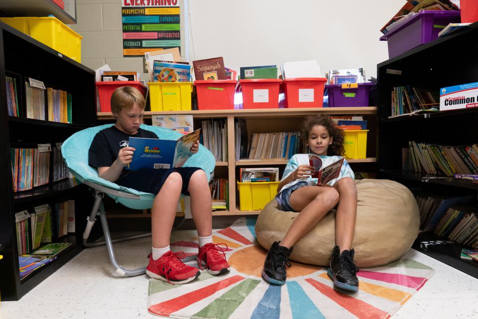 Ross Elementary fourth-graders Caius Bonsall, left, and Zara Douglas show their reading corner with comfy seats in Madison Bach's classroom Friday.
