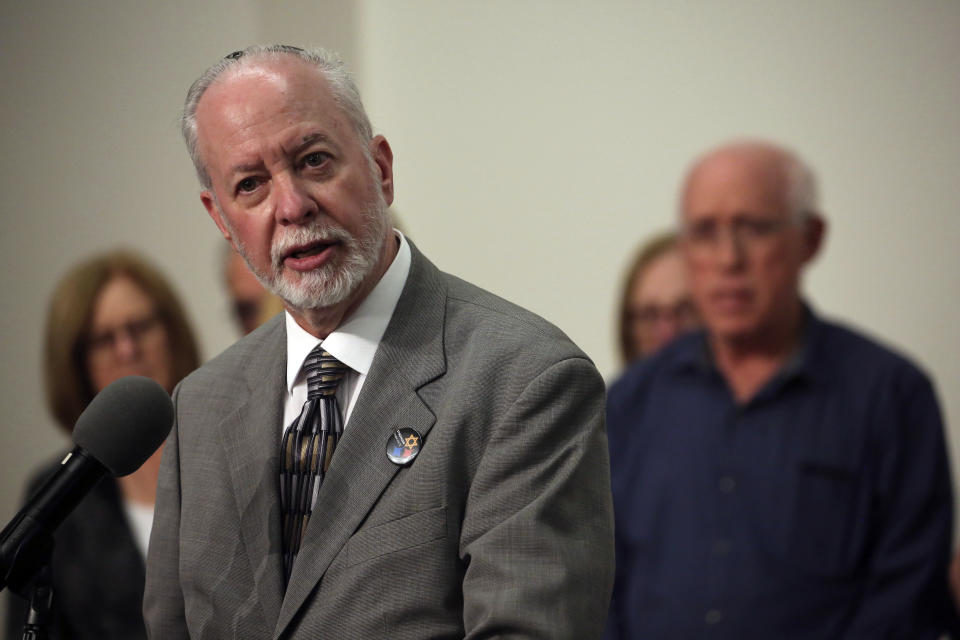 Rabbi Jeffrey Myers speaks to the media surrounded by victims and families of victims following the sentencing of Robert Bowers at the Jewish Community Center in Pittsburgh, Wednesday, Aug 2, 2023. Bowers was sentenced to death for killing 11 people at the Tree of Life synagogue in Pittsburgh in 2018. (AP Photo/Rebecca Droke)