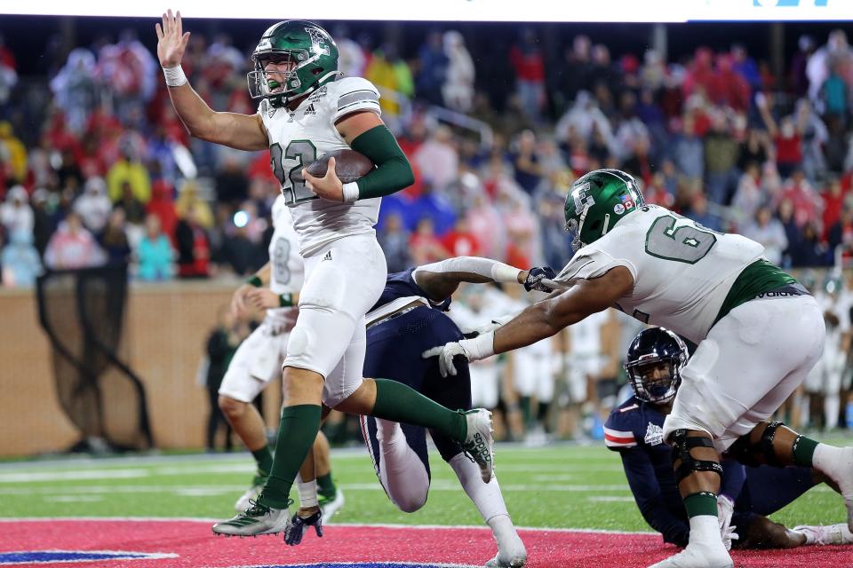Samson Evans (22) of the Eastern Michigan Eagles rushes for a touchdown during the first half of the LendingTree Bowl against the Liberty Flames at Hancock Whitney Stadium on Dec. 18, 2021 in Mobile, Alabama.