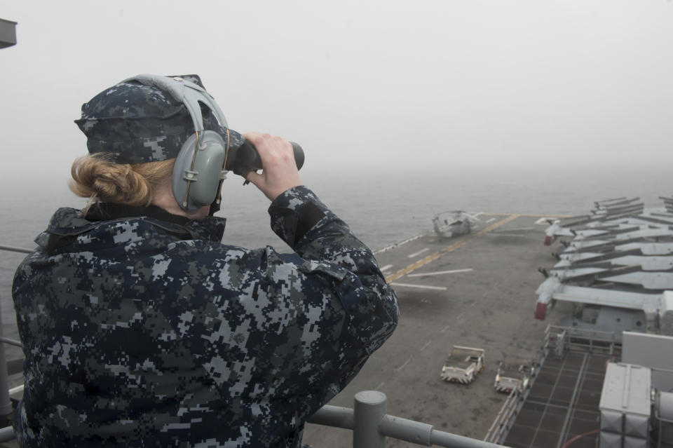 In this photo provided by the U.S. Navy, Boatswain's Mate Seaman Ashlee Stone, from Wichita, Kan., stands a low visibility watch aboard the amphibious assault ship USS Bonhomme Richard during search and rescue operations on Friday, April 18, 2014 after the South Korean ferry, the Sewol, flipped onto its side in the East China Sea. Rescuers are still searching for over 200 people still missing and feared dead. (AP Photo/U.S. Navy, Mass Communication Specialist 2nd Class Adam D. Wainwright)