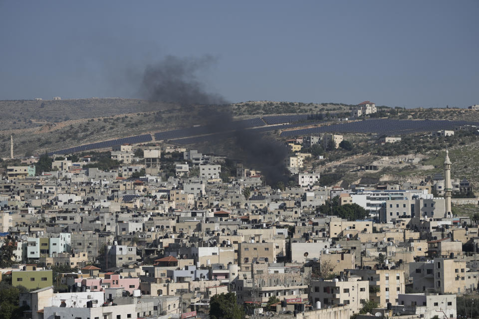 Smoke rises from the Fara'a refugee camp in the West Bank during an Israeli military raid on Monday, Dec. 18, 2023. (AP Photo/Majdi Mohammed)