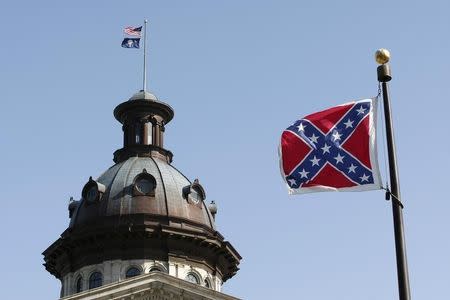 A Confederate flag flies at the base of a confederate memorial in front of the South Carolina State House in Columbia, South Carolina July 4, 2015. REUTERS/Tami Chappell