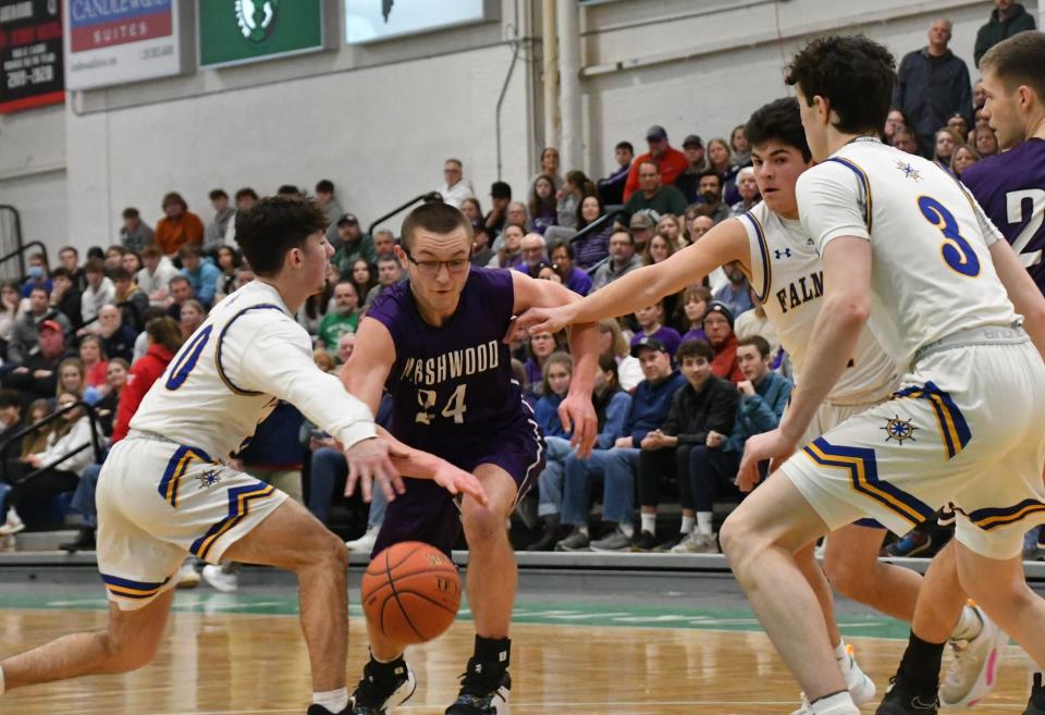 Marshwood’s Cooper Aiguier, center, splits the Falmouth defense during the Class A South championship game Friday night at the Portland Expo. Marshwood lost in the regional final for the second year in a row, 40-31