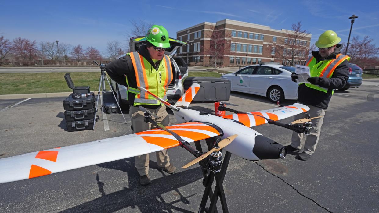 Ohio Department of Transportation chief drone pilot Daniel Kammer (left) and David Gallagher, flight operations manager of the unmanned aircraft section, examine the new ODOT fixed-wind drone on March 21, near Springfield, Ohio.